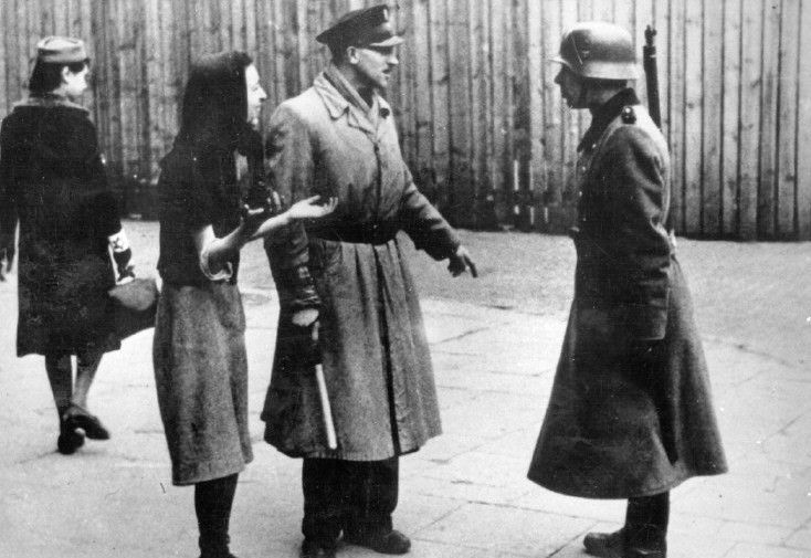 Jews speak to a Geman solider in the Warsaw ghetto